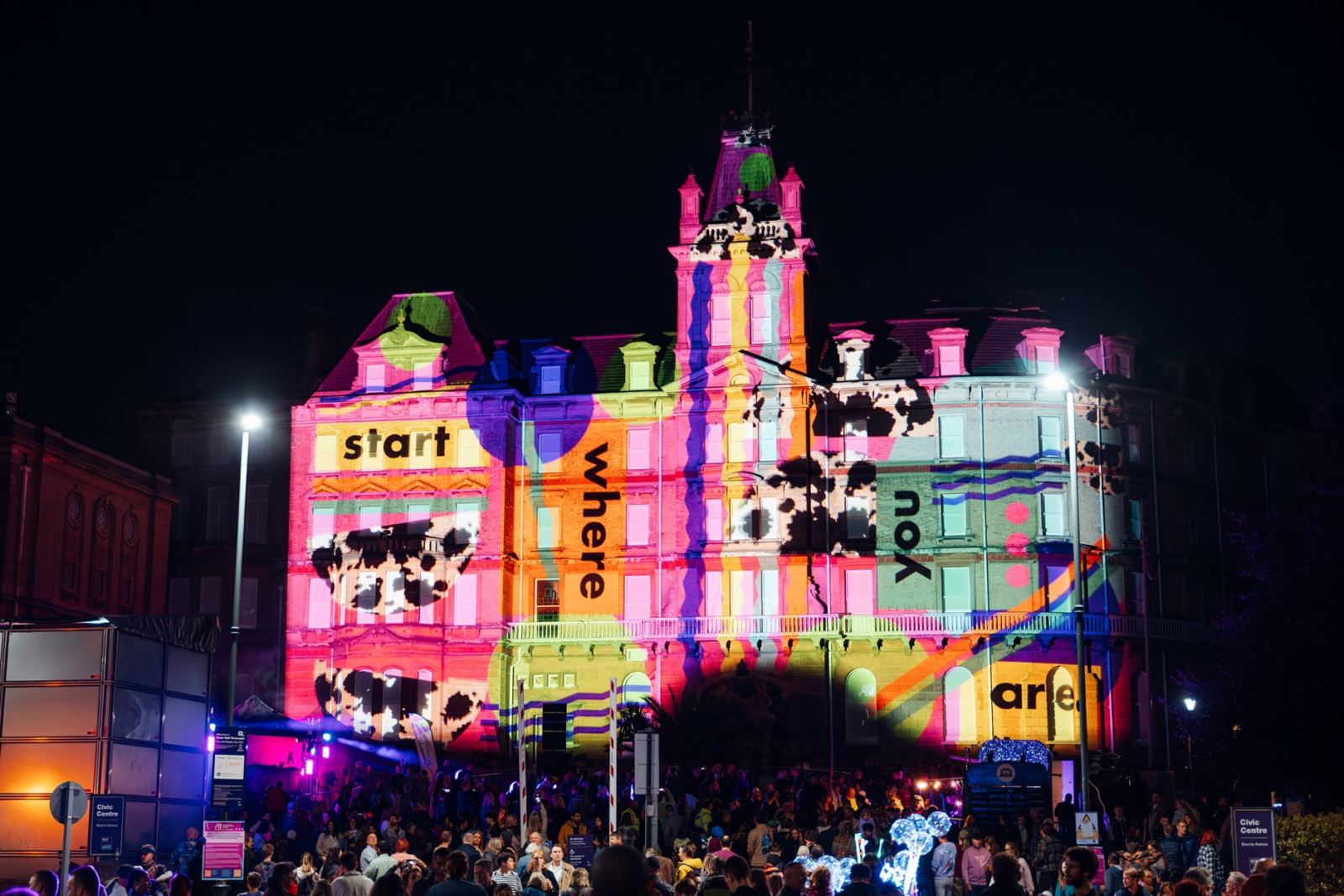 Bournemouth Civic Centre light up with colourful lights projecting on the building. 